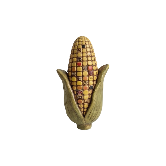 Folk art ear of corn with patterned kernels and green husk
