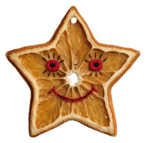 Whimsical orange star face ornament with embroidered eyes and smile