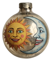 Vintage round ornament painted with smiling sun and crescent moon faces